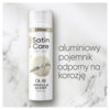 Puszka żelu do golenia o pojemności 200 ml z napisem "Satin Care Dry Skin Olay Vanilla Scent Shave Gel" na tle marmurowym. Obok znajduje się tekst: "aluminiowy pojemnik odporny na korozję".