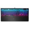 Na zdjęciu widoczna jest klawiatura z podświetleniem RGB, z wyraźnie oznaczonymi klawiszami funkcyjnymi i numerycznymi. Na klawiaturze znajduje się logo "SteelSeries" oraz ekranik z napisem "PROFILES".