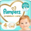Opakowanie pieluch Pampers Premium Care z dużym sercem w tle, zawiera tekst: "Pampers premium care", "4", "68", "9-14 KG" oraz grafikę dziecka. W prawym górnym rogu znajduje się okrągła etykieta z napisem "Delicate Comfort Care Stop & Protect Pocket".