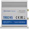 Srebrne urządzenie z logo "TELTONIKA Networks" i oznaczeniem modelu "TRB245" na froncie, z informacjami: "Made in Lithuania", "TELTONIKA NETWORKS UAB, K. Barsausko st. 66, LT-51436 Kaunas, Lithuania", oraz "Default IP: 192.168.1.1, User/Pass: admin/admin0