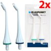 Na zdjęciu widoczne są dwie białe końcówki do irygatora z kolorowymi pierścieniami, obok opakowania z napisem "BLAUPUNKT REPLACEMENT ORTHODONTIC TIPS ACC035". W prawym górnym rogu znajduje się duży czerwony napis "2x".