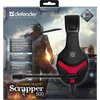 Opakowanie przedstawia czarno-czerwone słuchawki na tle postapokaliptycznego krajobrazu z postacią trzymającą miecz. Widoczny tekst to: "defender TRIFLES MAKE PERFECTION", "Compatible with laptop and desktop PCs, game consoles, smartphones and tablets", "