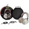 Na zdjęciu widoczne są beżowo-białe słuchawki nauszne, okrągłe opakowanie z napisem "SHURE AONIC50 WIRELESS HEADPHONES" oraz czarne etui z logo. Obok znajdują się dwa kable z różnymi końcówkami.