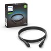 Na zdjęciu znajduje się czarny kabel zasilający z dwoma złączami oraz pudełko z napisem "PHILIPS hue Personal Wireless Lighting Accessories Cable Extension 2.5 meters" i oznaczeniem "Low voltage". Na opakowaniu widoczna jest także zielona ikona z napisem 