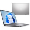 Na zdjęciu widoczny jest laptop z otwartym ekranem, na którym wyświetlany jest pulpit systemu Windows 11 z ikonami aplikacji. Obok znajduje się zamknięta pokrywa laptopa z logo "Dell" na środku.