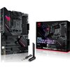 Na zdjęciu znajduje się płyta główna z widocznymi złączami i komponentami, obok której stoi pudełko z napisem "ROG Strix B550-F Gaming WiFi II". Na pudełku widoczne są także logotypy i oznaczenia technologiczne, takie jak "WiFi 6" i "B550".