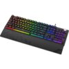 Czarna klawiatura mechaniczna z podświetleniem RGB, z widocznymi kolorowymi klawiszami w odcieniach czerwieni, żółci, zieleni, niebieskiego i fioletu. Na podpórce na nadgarstki widoczne jest logo "KRUX".