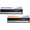 Dwa moduły pamięci RAM z serii Trident Z5 RGB, z widocznymi napisami "Trident Z5 RGB" na czarnym tle, mają srebrne obudowy z kolorowymi elementami RGB na górze. Każdy moduł posiada złote złącza na dolnej krawędzi.