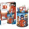 Na zdjęciu znajduje się opakowanie oraz złożony produkt "Puzzle 3D RAVENSBURGER Miraculous Przybornik 11278 (54 elementy)". Na opakowaniu widnieje napis "3D Puzzle" oraz "Sturdy - no glue required", a także logo "Ravensburger".