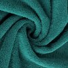 Turkusowy ręcznik o fakturze frotte, zwinięty w spiralny kształt, ukazujący miękką i puszystą strukturę materiału.