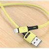 Żółty kabel USB-Lightning leży na drewnianej powierzchni, z widocznymi złączami USB i Lightning. Na obudowie złącza USB znajduje się napis "USAMS".