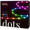 Na zdjęciu znajduje się opakowanie lampek choinkowych LED z napisem "twinkly GENERATION II", "400 MULTICOLOR", "APP CONTROLLED RGB LED" oraz dużym napisem "dots". Widoczne są kolorowe, świecące punkty ułożone w okręgi na ciemnym tle.
