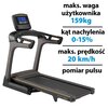 Na zdjęciu znajduje się bieżnia elektryczna z wyświetlaczem, na którym widoczne są przyciski sterujące. Obok bieżni umieszczono tekst: "maks. waga użytkownika 159kg, kąt nachylenia 0-15%, maks. prędkość 20 km/h, pomiar pulsu".