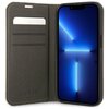 Etui na telefon w kolorze różowym z otwartą klapką, wewnątrz której znajdują się trzy kieszonki na karty oraz wytłoczone logo "GUESS". Obok etui znajduje się telefon z wyświetlaczem pokazującym niebieski, abstrakcyjny wzór świetlny.