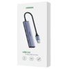 Białe opakowanie z wizerunkiem szarego huba USB z czarnym kablem, na którym widnieje napis "UGREEN". Na opakowaniu znajduje się tekst: "USB 3.0 4-Port USB 3.0 Hub" oraz trzy ikony z symbolami.