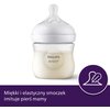 Przezroczysty smoczek z butelką, na której widnieje napis "PHILIPS AVENT". Na dole zdjęcia znajduje się fioletowy pasek z tekstem: "Miękki i elastyczny smoczek imituje pierś mamy" oraz ikoną smoczka z piórkiem.