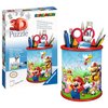 Pudełko z puzzlami 3D przedstawia przybornik z motywem Super Mario, z kolorowymi postaciami z gry na tle zielonego krajobrazu. Na opakowaniu widnieje napis "3D Puzzle" oraz "Ravensburger", a także informacje o stabilności i braku potrzeby użycia kleju w k