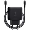 Czarny zasilacz do laptopa z logo "Trust" na obudowie, z dwoma wtyczkami USB-C i przewodem owiniętym wokół urządzenia. Produkt ma europejską wtyczkę elektryczną.