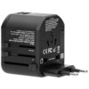 Czarny adapter podróżny z widocznymi gniazdami i wtyczkami, oznaczony jako "TA-6 WORLD TRAVEL ADAPTER WITH 2 USB". Na urządzeniu znajdują się oznaczenia certyfikatów CE, FCC, RoHS oraz ostrzeżenia dotyczące użytkowania.