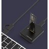 Czarna stacja dokująca do dysków z włożonym dyskiem SSD, podłączona do laptopa za pomocą kabla USB. Na stacji widoczny jest napis: "M.2 NVME SSD Docking Station".