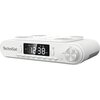 Białe radio analogowe marki TechniSat z wyświetlaczem cyfrowym pokazującym godzinę 12:38 oraz przyciskami funkcyjnymi poniżej, takimi jak "LIGHT", "MODE/RESET", "MEM/PAIR", "TUN-/H", "TUN+/M", "ALARM", "TIMER". Po prawej stronie znajduje się pokrętło z oz