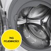 Obraz przedstawia wnętrze bębna pralki z widocznymi metalowymi perforacjami. Na żółtym tle znajduje się napis "7KG POJEMNOŚCI", wskazujący na maksymalną ładowność urządzenia.