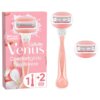 Na zdjęciu znajduje się różowe opakowanie z napisem "Gillette Venus Comfortglide Spa Breeze" oraz ilustracją golarki. Obok opakowania widoczna jest różowa golarka i dwa wymienne wkłady.