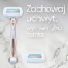 Na marmurowym tle znajduje się różowo-złota golarka z wymiennym ostrzem oraz dodatkowe ostrze, obok widoczny jest tekst: "Zachowaj uchwyt, wymień tylko ostrza."