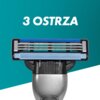 Na zdjęciu widoczna jest głowica golarki z trzema ostrzami, na tle turkusowego gradientu. Nad nią znajduje się napis "3 OSTRZA".