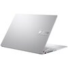 Na zdjęciu widoczny jest srebrny laptop z otwartą pokrywą, na której znajduje się logo "ASUS Vivobook". Klawiatura jest częściowo widoczna, a na obudowie widać kilka portów i przycisków.