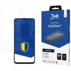 Na zdjęciu widoczny jest telefon z nałożonym szkłem ochronnym oraz opakowanie produktu "3mk Protection HardGlass™". Opakowanie zawiera informacje takie jak "9H hardness", "FIT-IN™ technology" oraz logo "3mk".