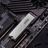 Na zdjęciu widoczny jest dysk SSD z napisem "XPG" zamontowany na płycie głównej komputera. Na płycie głównej znajdują się napisy "MADE IN CHINA" oraz różne elementy elektroniczne i złącza.