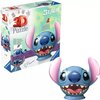 Pudełko z puzzlami 3D przedstawia postać z bajki Disney Stitch, z dużymi różowymi uszami i szerokim uśmiechem. Na opakowaniu widnieje napis "3D Puzzle" oraz logo "Ravensburger".