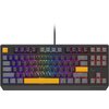Klawiatura mechaniczna z podświetleniem RGB, posiadająca klawisze w różnych kolorach, w tym pomarańczowy klawisz "Esc" i "Spacja". Na obudowie widoczne jest logo "Genesis".