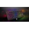 Na zdjęciu znajduje się czarna klawiatura mechaniczna z podświetleniem RGB, obok której leży mały odbiornik USB. W tle widoczne jest duże, półprzezroczyste słowo "THOR", a na klawiaturze znajduje się logo "GENESIS".