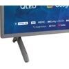 Fragment telewizora z szarymi ramkami i podstawą, na ekranie widoczne są napisy: "QLED", "Google TV", "4K ULTRA HD", "HDR", "MEMC", "Dolby VISION", "Google Assistant", "NETFLIX", "YouTube".