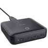Czarny zasilacz do laptopa z logo "Trust" na górze, posiadający cztery porty: jeden USB oznaczony jako 65W, dwa porty USB-C oznaczone jako 100W oraz jeden port USB-A. Na powierzchni znajduje się okrągły wskaźnik świetlny.