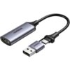 Na zdjęciu widoczny jest adapter z logo "UGREEN", składający się z kabla z końcówką HDMI oraz dwóch złączy: USB i USB-C. Adapter ma metaliczną obudowę w kolorze szarym.