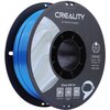 Zdjęcie przedstawia szpulę niebieskiego filamentu do drukarki 3D marki Creality, z widocznym napisem "CREALITY 3D PRINTER FILAMENT" na etykiecie. Na etykiecie znajdują się również informacje: "CR-PLA SILK", "Diameter: 1.75MM", "Net Weight: 1KG", "Extruder