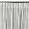 Biała zasłona o wymiarach 140 x 270 cm z delikatnym, ażurowym wzorem, zawieszona na metalowym karniszu. Produkt to "Zasłona EUROFIRANY Aleksa".