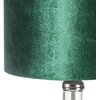 Ciemnozielony abażur lampy stołowej o teksturowanej powierzchni, zamocowany na przezroczystej podstawie z metalowym elementem. Produkt to "Lampa stołowa EUROFIRANY Kim 352173 Ciemnozielony".