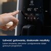 Na zdjęciu widoczna jest frytkownica beztłuszczowa z panelem dotykowym, na którym wyświetlana jest temperatura 185°C i czas 15 minut, oraz przyciski "Airfry", "Bake" i "Reheat". W dolnej części zdjęcia znajduje się tekst: "Łatwość gotowania, doskonałe rez