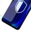 Na zdjęciu widoczny jest fragment smartfona z nałożonym szkłem ochronnym, na ekranie którego znajduje się niebieski wzór z białymi kropkami i liniami oraz białą ikoną tarczy. Szkło ochronne jest lekko uniesione, co podkreśla jego przezroczystość i dopasowanie do ekranu urządzenia.