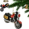 Na zdjęciu widoczna jest bombka w kształcie motocykla, zawieszona na gałązce choinki. W górnej części zdjęcia znajduje się logo z napisem "CHRISTMAS Jolly Tree Decoration".