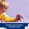 Na zdjęciu znajduje się zestaw klocków LEGO przedstawiający dużego, czerwono-niebieskiego mecha z motywem Spider-Mana, trzymającego białą sieć. Obok mecha stoi mała, biała figurka z czarnym wzorem na torsie, przypominającym pająka.