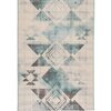Dywan zewnętrzny o wymiarach 120 x 170 cm w kolorze turkusowym, z geometrycznym wzorem w odcieniach beżu i brązu. Wzór składa się z rombów i trójkątów, tworzących symetryczny układ.