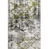 Dywan wewnętrzny o wymiarach 120 x 170 cm w kolorze zielonym, z wzorem przypominającym abstrakcyjne plamy i kratkę w odcieniach bieli, czerni i szarości. Wzór jest nieregularny, z dominującymi zielonymi akcentami.