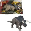 Pudełko z figurką dinozaura Nasutoceratops z serii Jurassic World, z widocznym logo Jurassic World i Mattel oraz tekstem "Nasutoceratops". Figurka przedstawia szaro-niebieskiego dinozaura z dużymi rogami i szczegółową fakturą skóry.