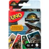 Opakowanie gry karcianej UNO z motywem Jurassic World, z widocznymi kartami przedstawiającymi dinozaury oraz tekstem: "INCLUDES A SPECIAL RULE! AVEC UNE RÈGLE SPÉCIALE! ¡INCLUYE UNA REGLA ESPECIAL! INCLUI UMA REGRA ESPECIAL!". Na opakowaniu znajdują się również logotypy "UNO" i "Jurassic World Rebirth", a także oznaczenia wiekowe i liczby graczy.