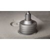Na zdjęciu widoczny jest metalowy adapter do otwornic GRAPHITE 55H330, który jest używany do wiercenia otworu w jasnym, betonowym bloku. Adapter ma cylindryczny kształt z wyraźnymi, poziomymi rowkami na powierzchni.